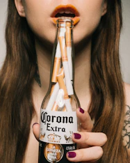 woman holding Corona Extra beer bottle