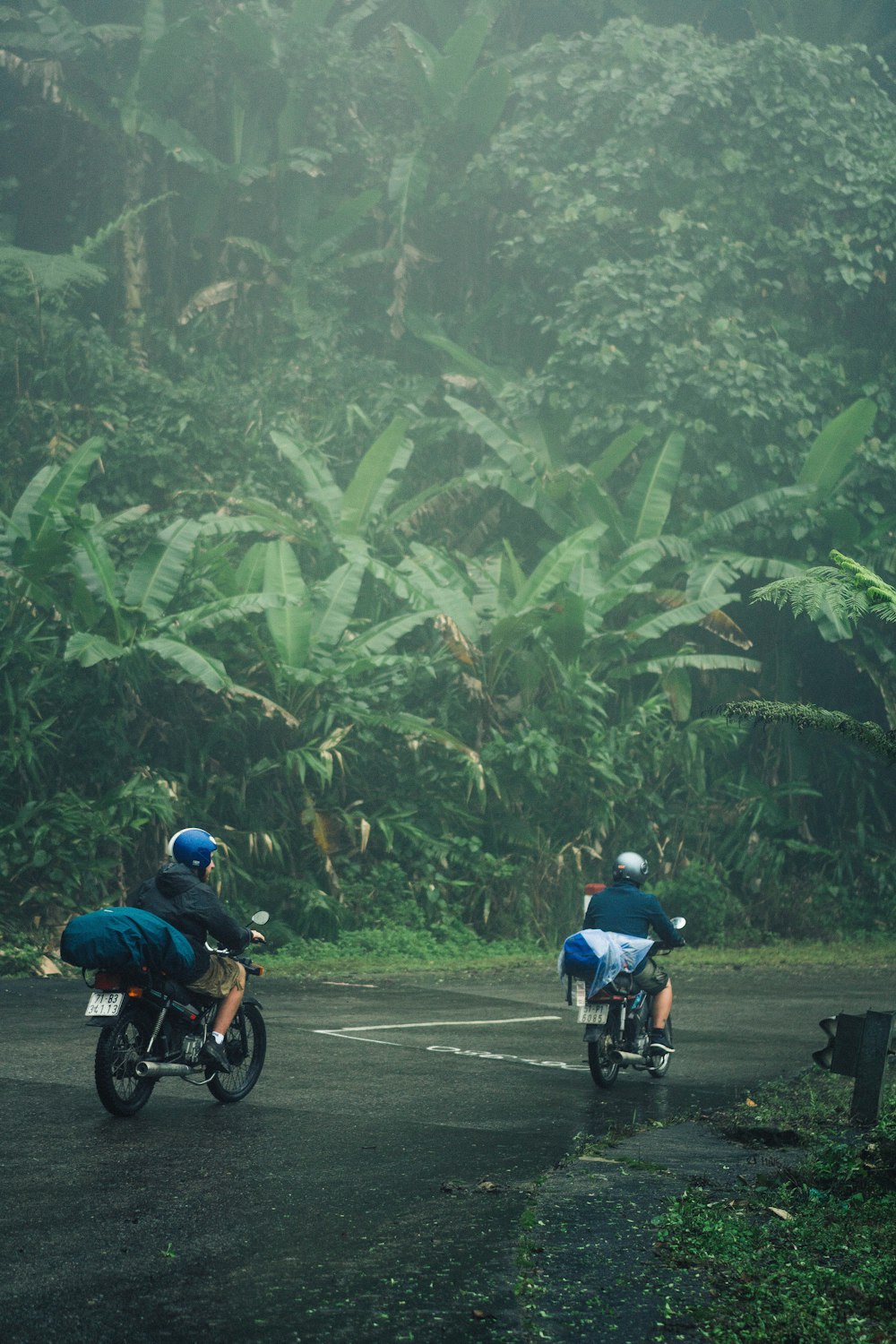 two people riding motorcycles