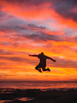 silhouette of person jumping above ground