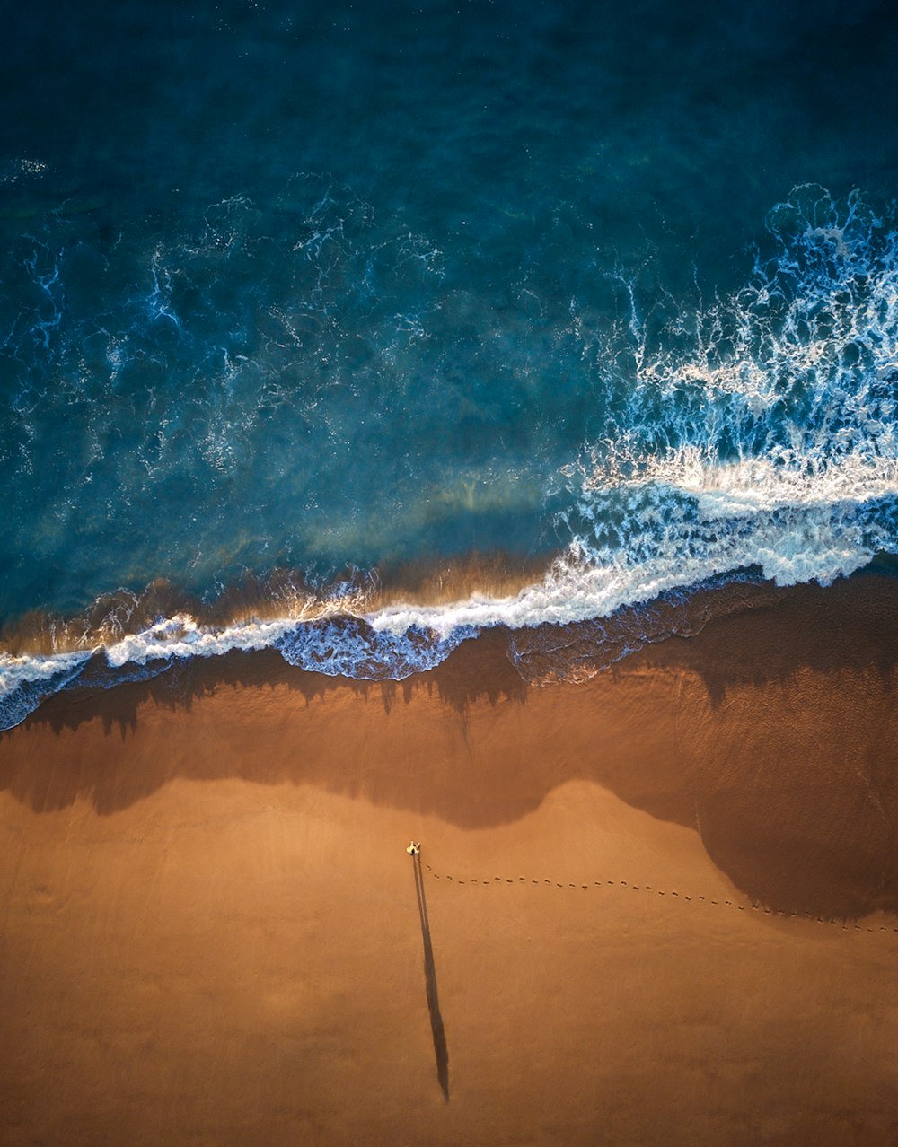 high angle photo of shoreline and ocean waves