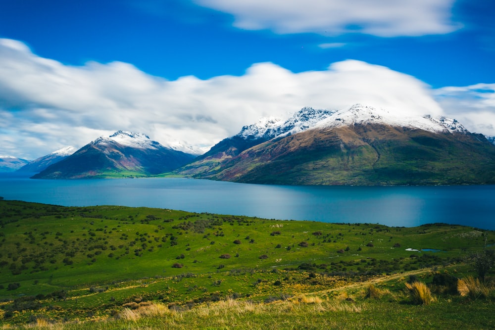 green mountain under white clouds