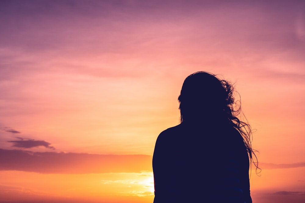 silhouette photo of woman's back