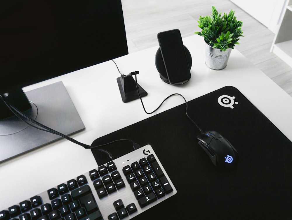 greyscale photography of keyboard beside mouse on table