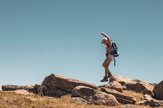 man walking on rock formation