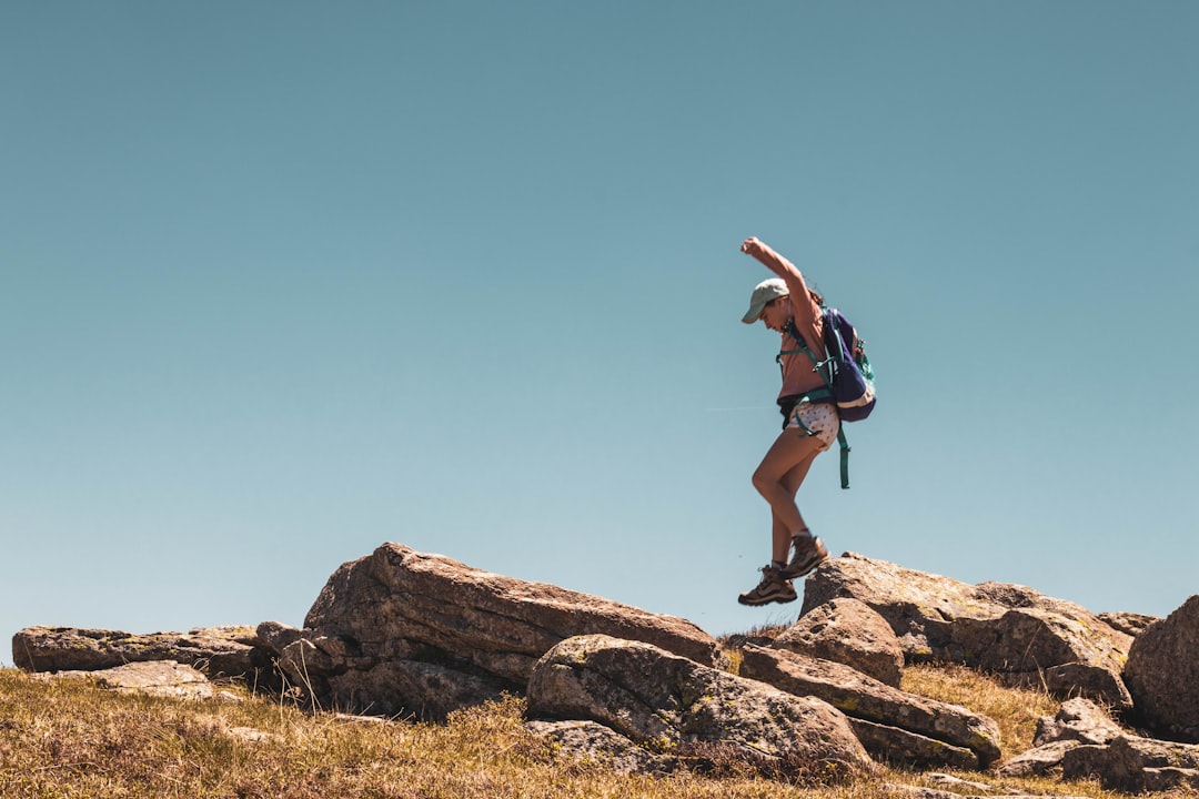 man walking on rock formation,