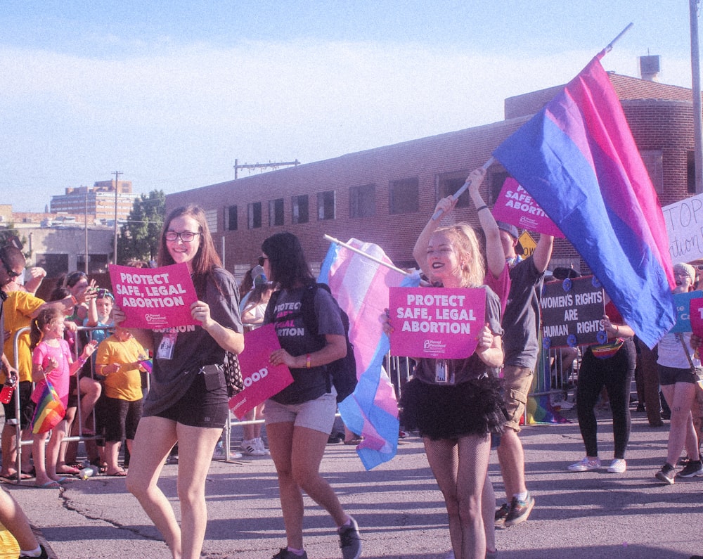 people holding signages parading near buildings