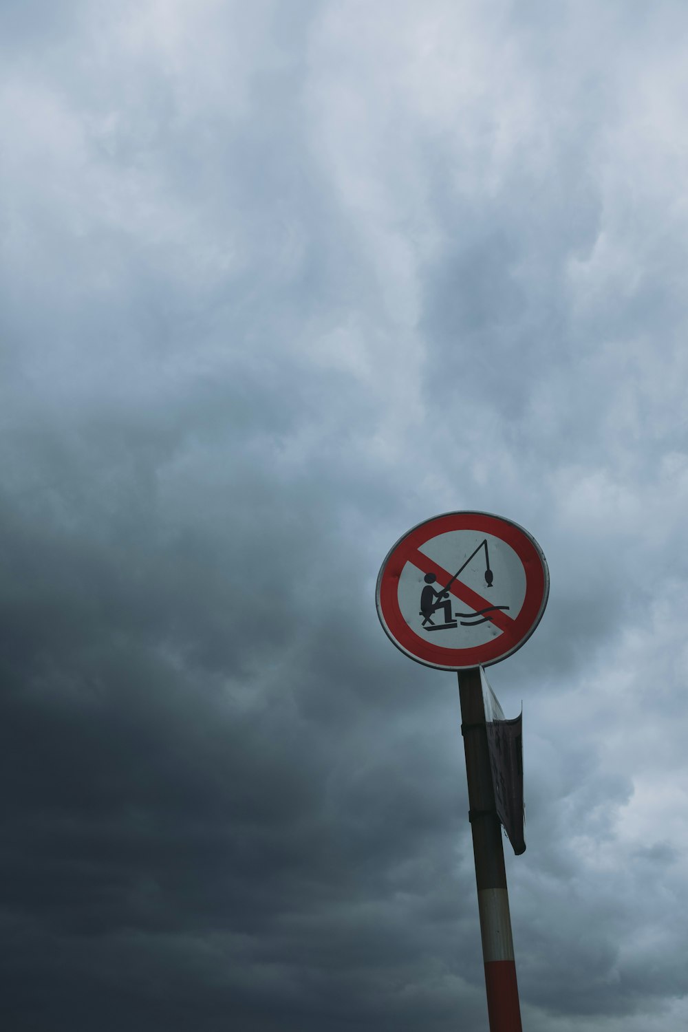 no fishing signage under cloudy sky