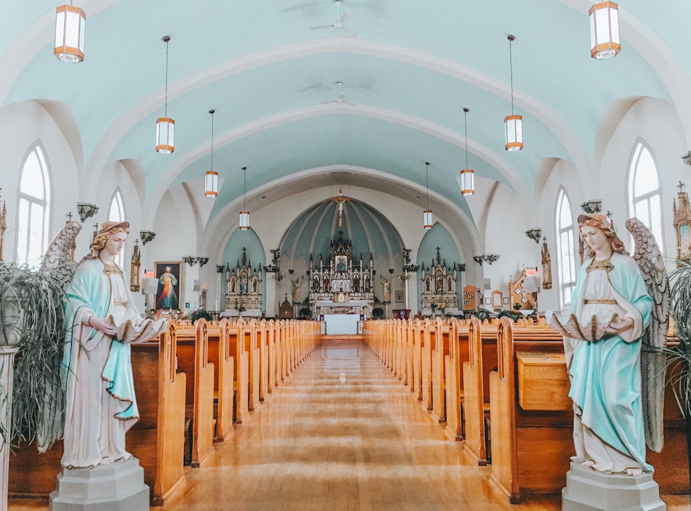 two angel statues placed on both aisle inside church