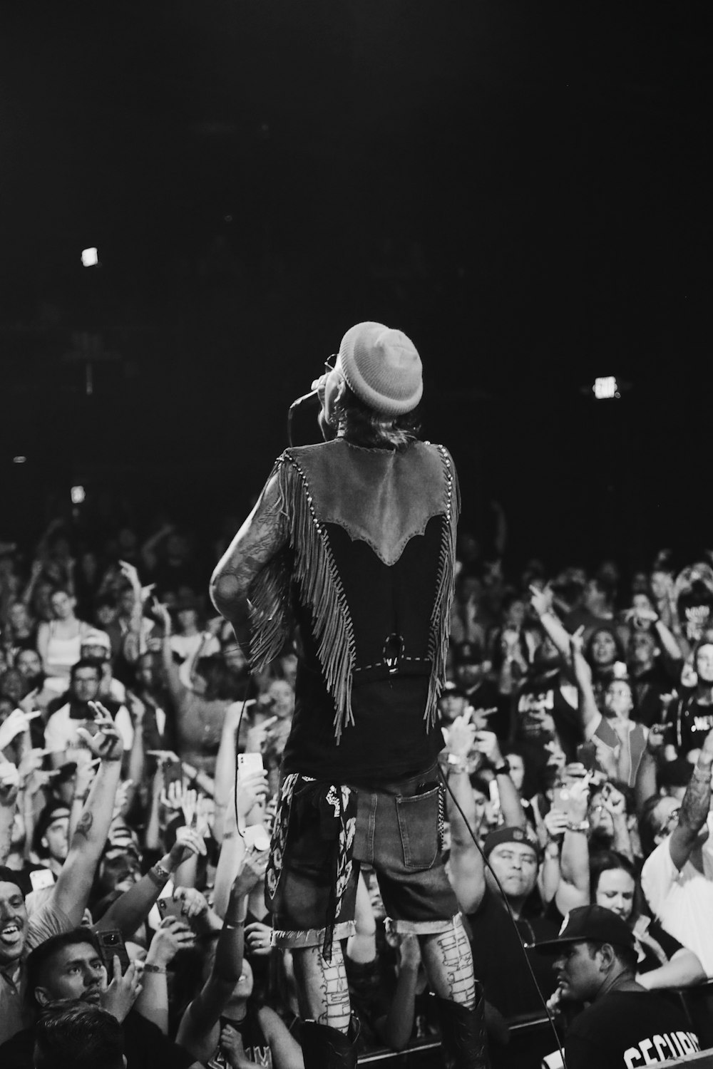 grayscale photo of man holding dynamic microphone