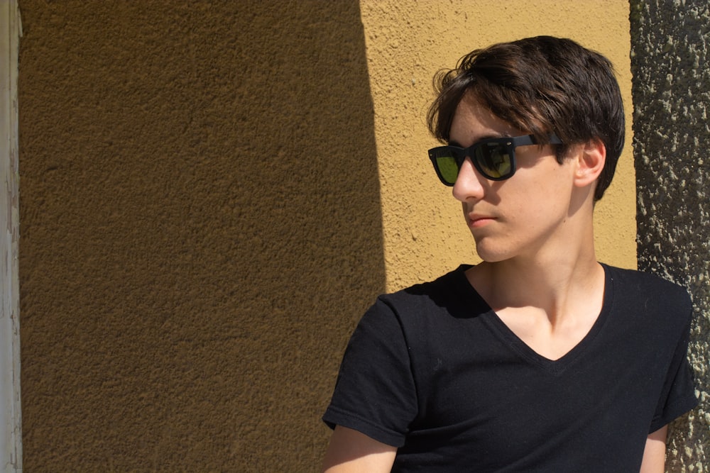 man in black V-neck shirt and black-framed sunglasses