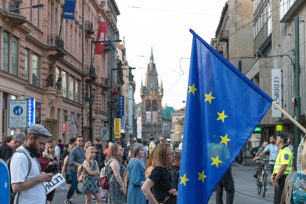 people walking on road between buildings