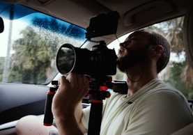 man taking photo inside vehicle