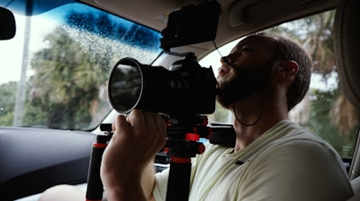 man taking photo inside vehicle