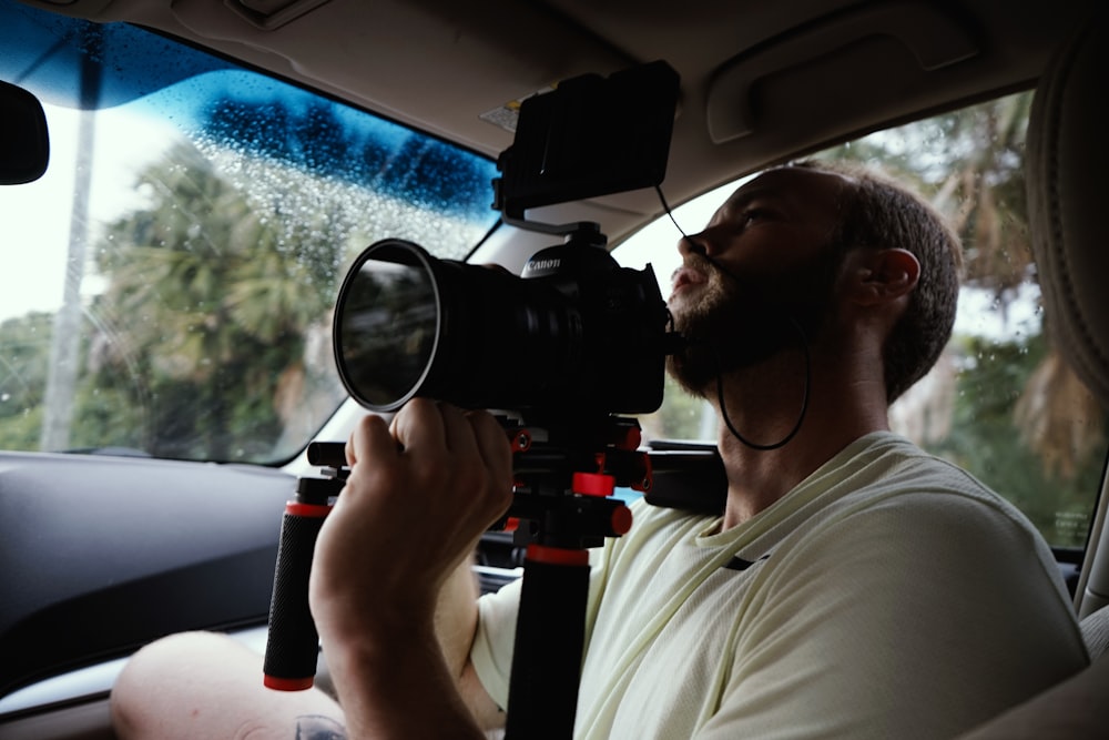 man taking photo inside vehicle