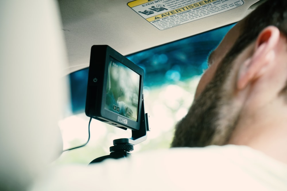a man is taking a picture of himself in a car
