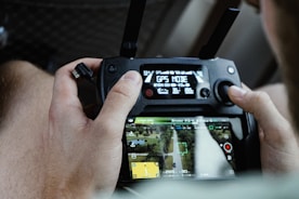 person holding drone controller