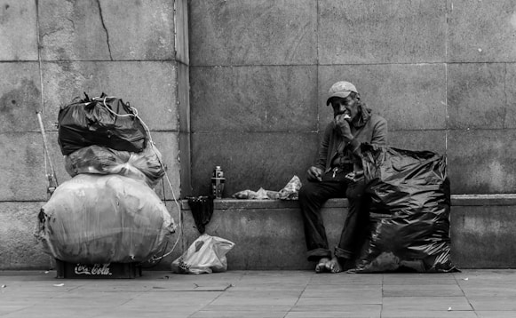 man sitting beside wall