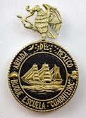 A decorative emblem features a golden eagle with outstretched wings perched on a circular crest. Inside the crest, a detailed gold depiction of a sailing ship with three masts is surrounded by stars and celestial symbols. The text around the circle reads 'ARMADA DE MEXICO BUQUE ESCUELA 'CUAUHTEMOC'.'
