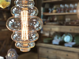 A custom decorative light fixture glowing warmly in a boutique setting.