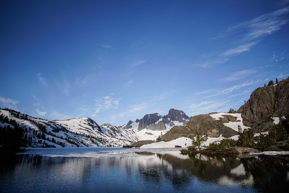 body of water beside mountain