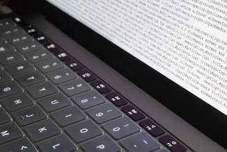 Close-up of hands typing commands on a laptop terminal with penetration testing scripts.