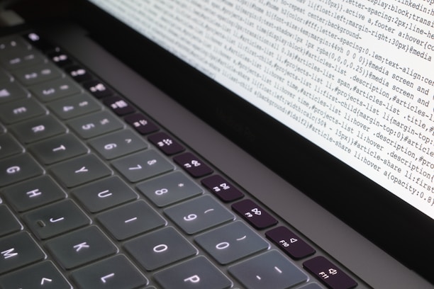 Close-up of hands typing commands on a keyboard with a Linux terminal open on the screen.