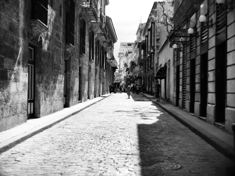 a black and white photo of a cobblestone street