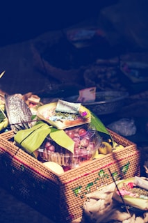 Brightly painted ceramic fruits arranged on a woven basket