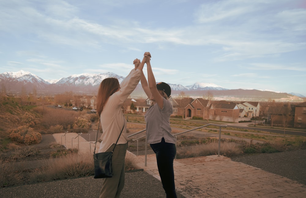 women railing both arms