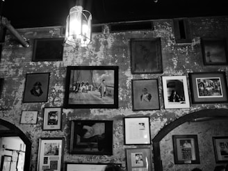 A skilled technician carefully hanging an elegant framed artwork in a cozy living room.