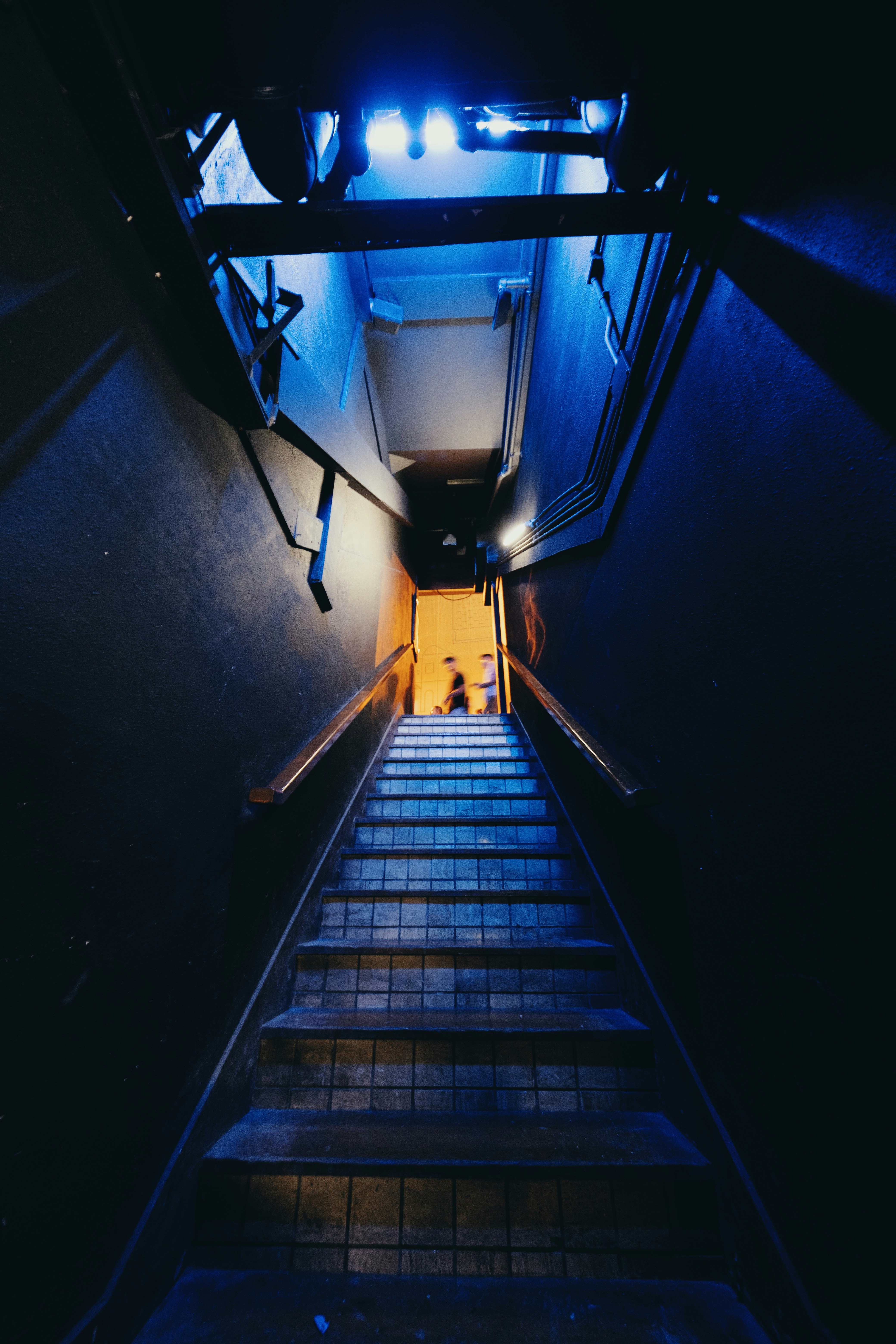 photo of black and gray staircase with blue LED lights