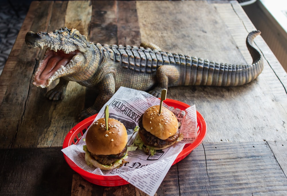 two sliders on plate beside crocodile statuette