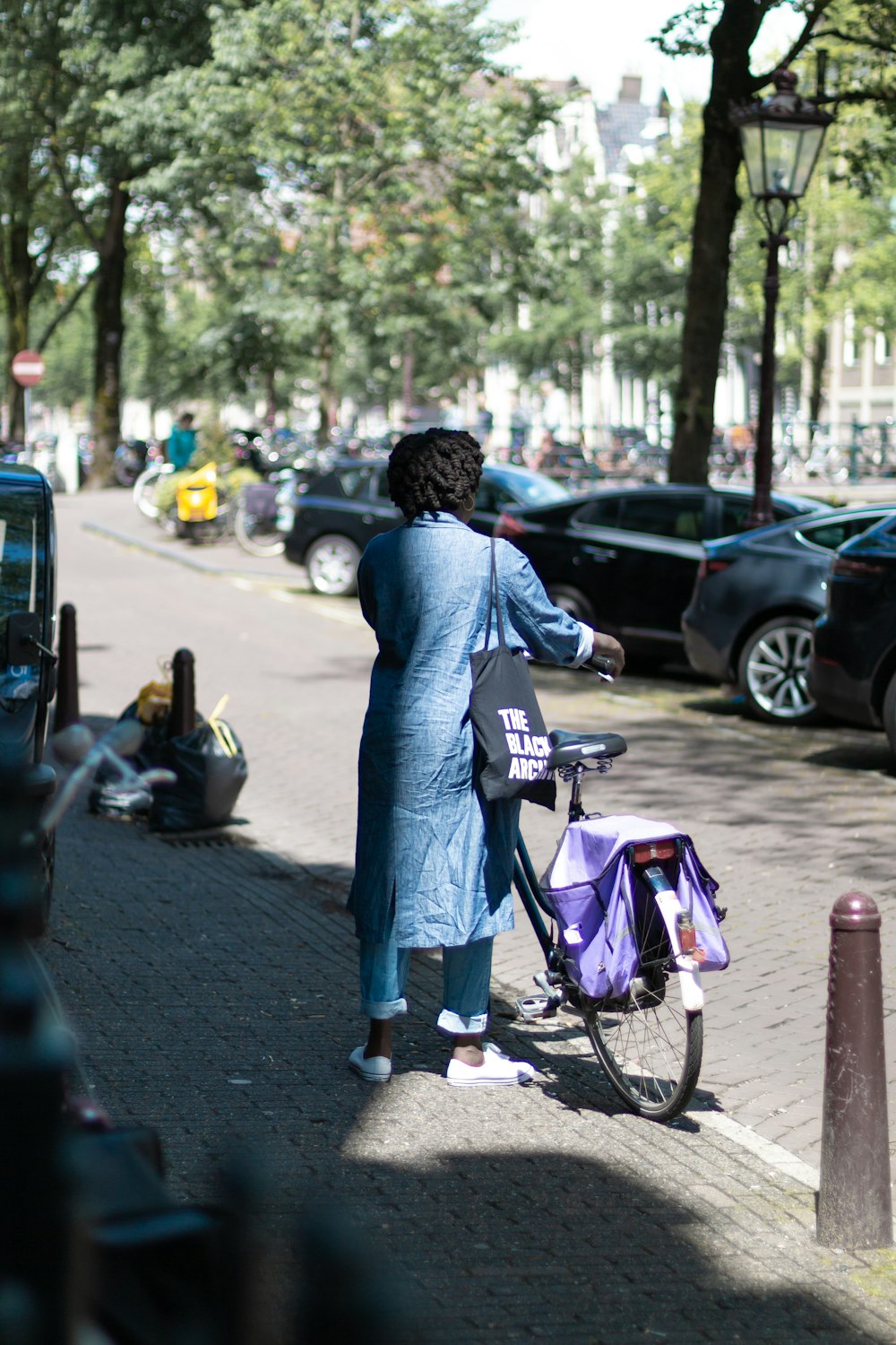 woman standing in front of bicycle during daytime