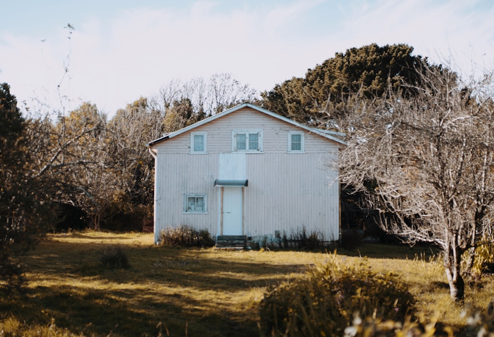 white concrete house surrounded by trees during daytime