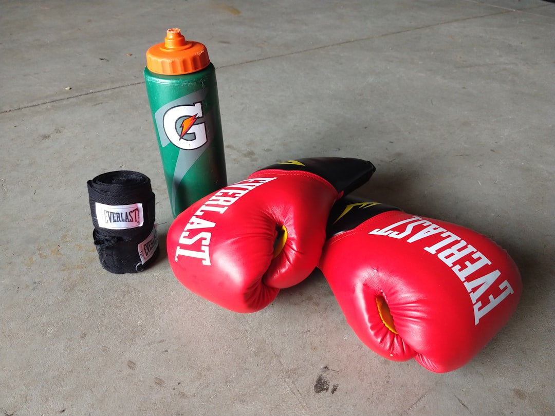 pair of red Everlast boxing gloves beside Gatorade bottle