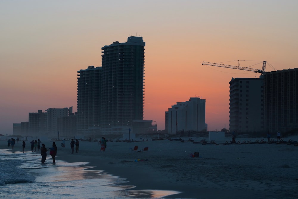 silhouette photography of people standing near buildings