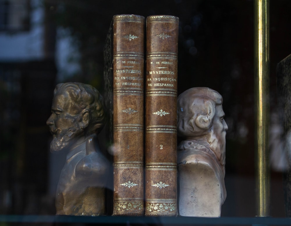 a couple of books sitting on top of a shelf