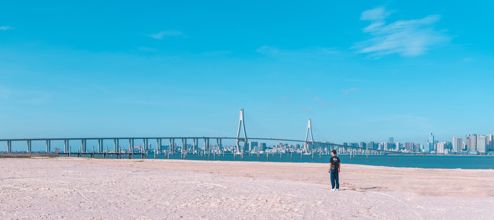 person standing in sand during daytime