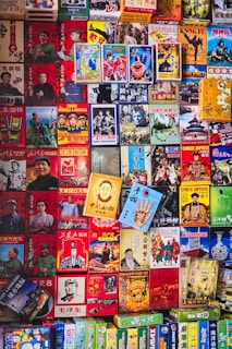 A vibrant collage of various colorful posters and books, featuring a mix of historical, cultural, and entertainment themes. The items are densely arranged, showcasing images of people, historical events, and possibly fictional characters, with a predominant use of Chinese text.