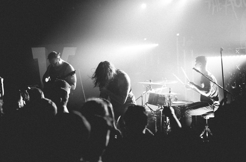 a black and white photo of a band on stage