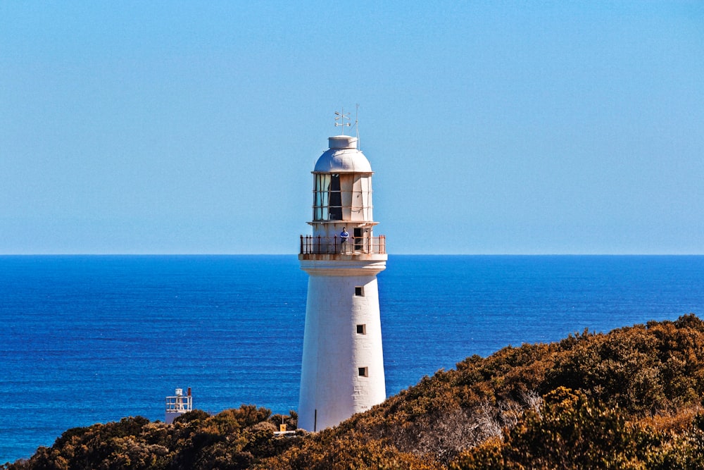 white lighthouse near body of water