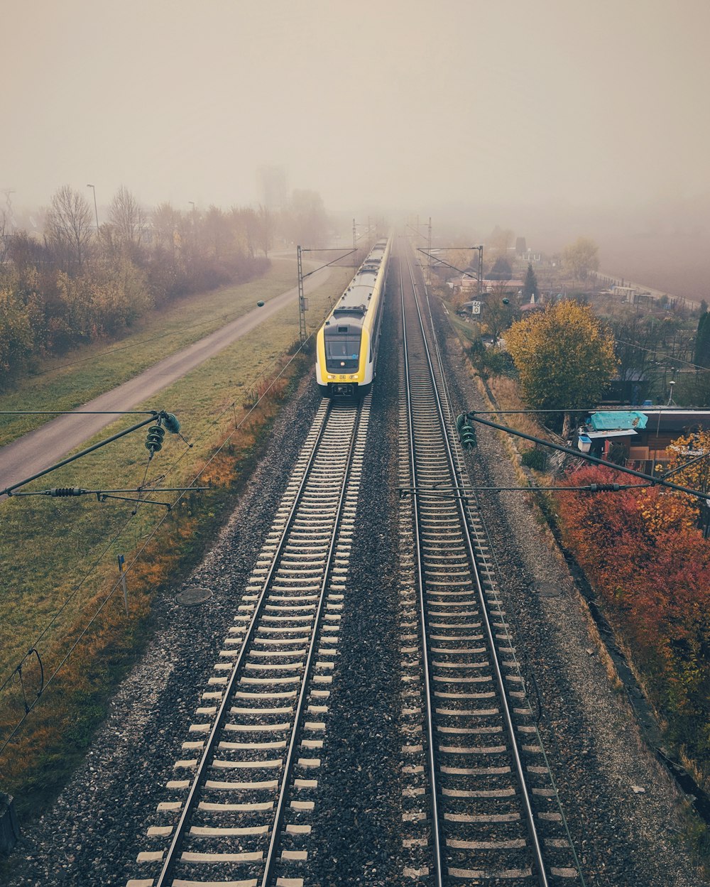 yellow train under grey sky