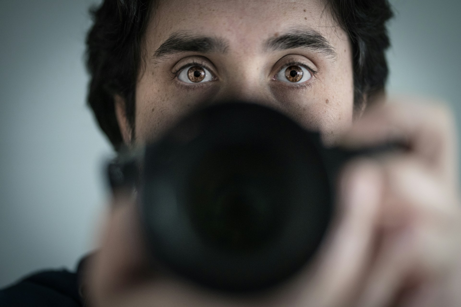 A close-up shot of a photographer adjusting his camera, capturing the moment with focus and intent.