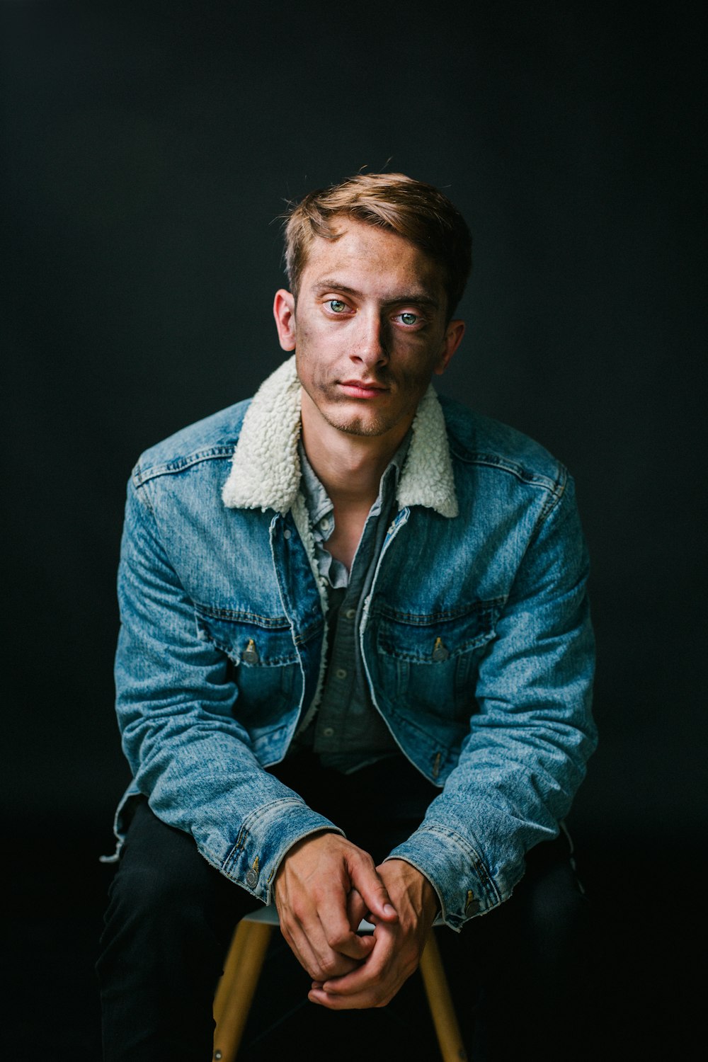 man wearing blue denim jacket