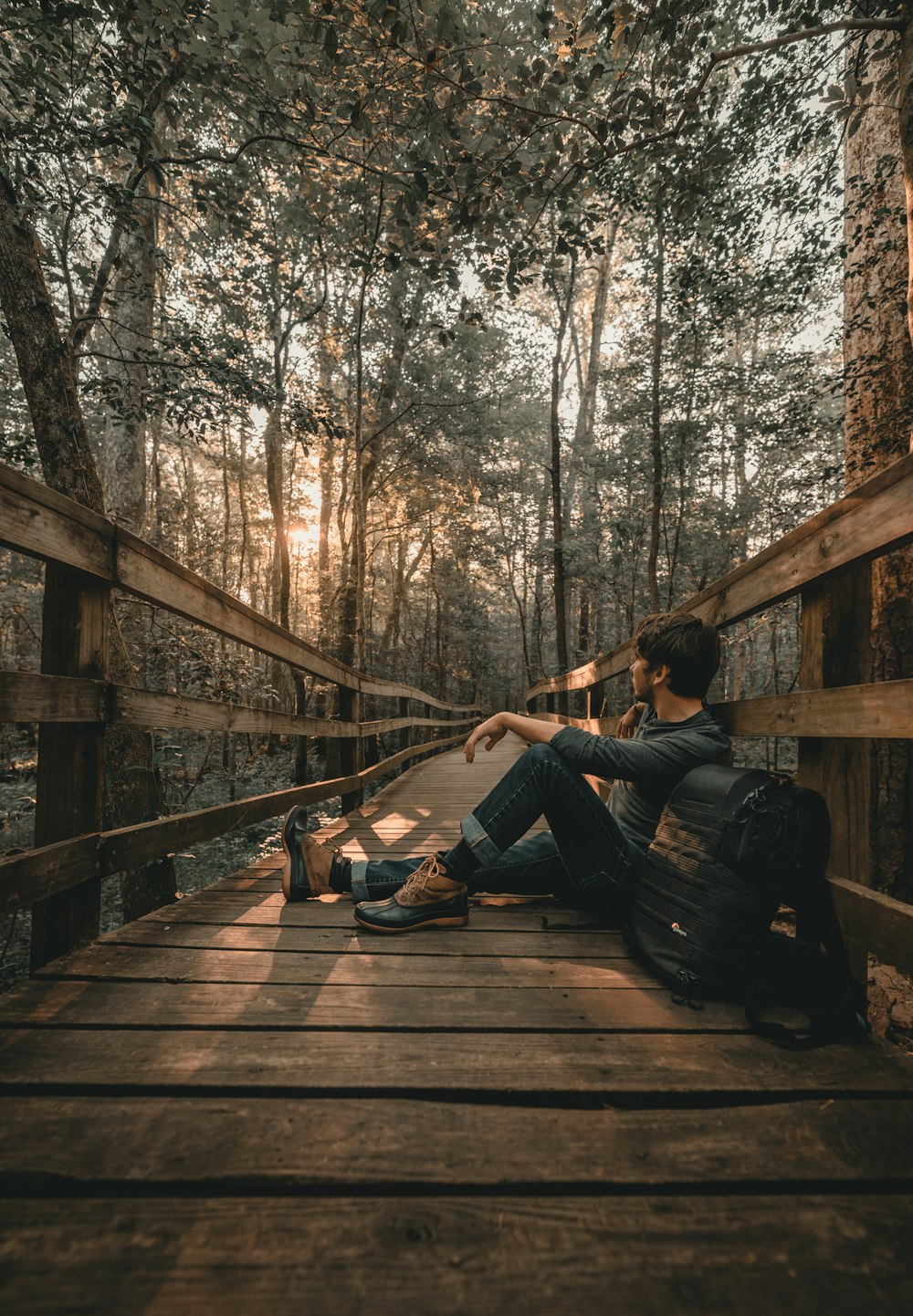 man leaning on bridge