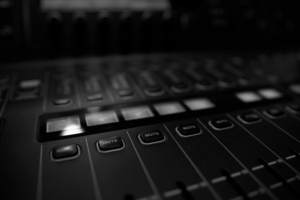 a black and white photo of a sound mixing console