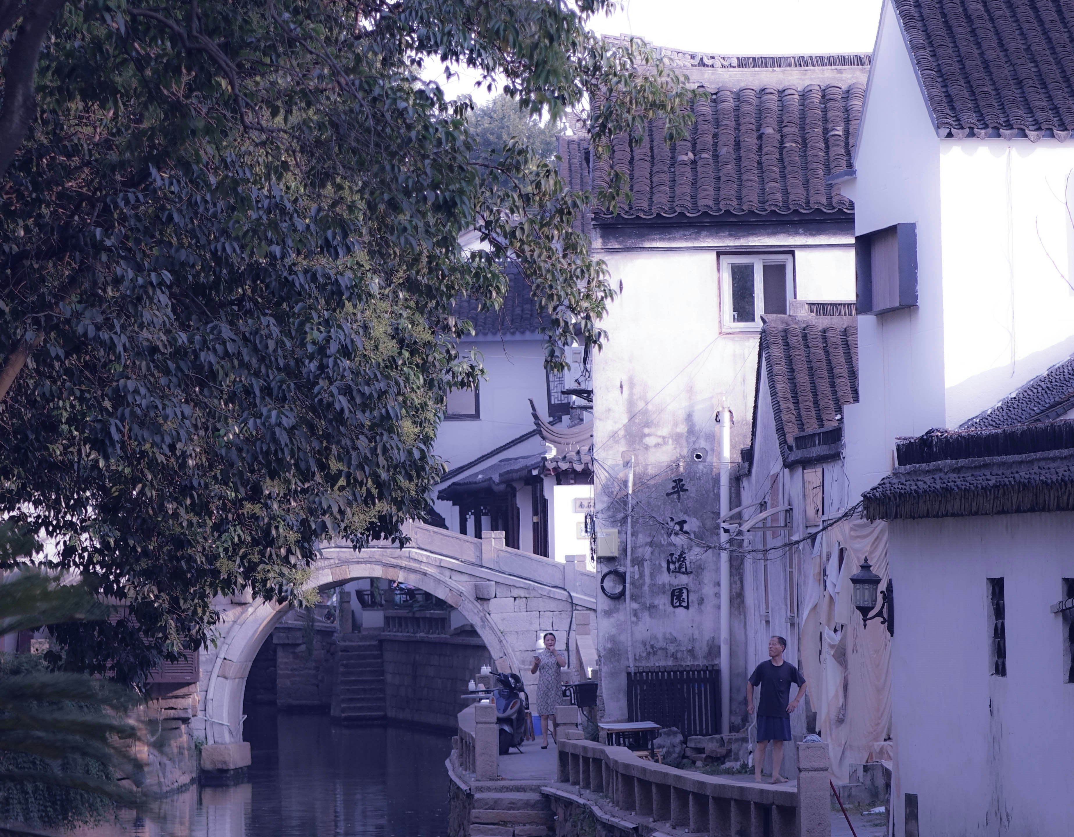 Few People Standing Near White And Black Concrete Building Photo