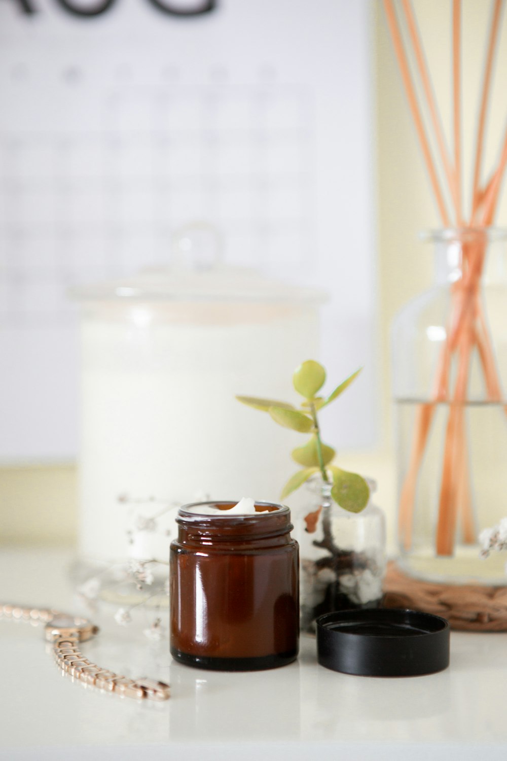 green leafed plant and items on white surface