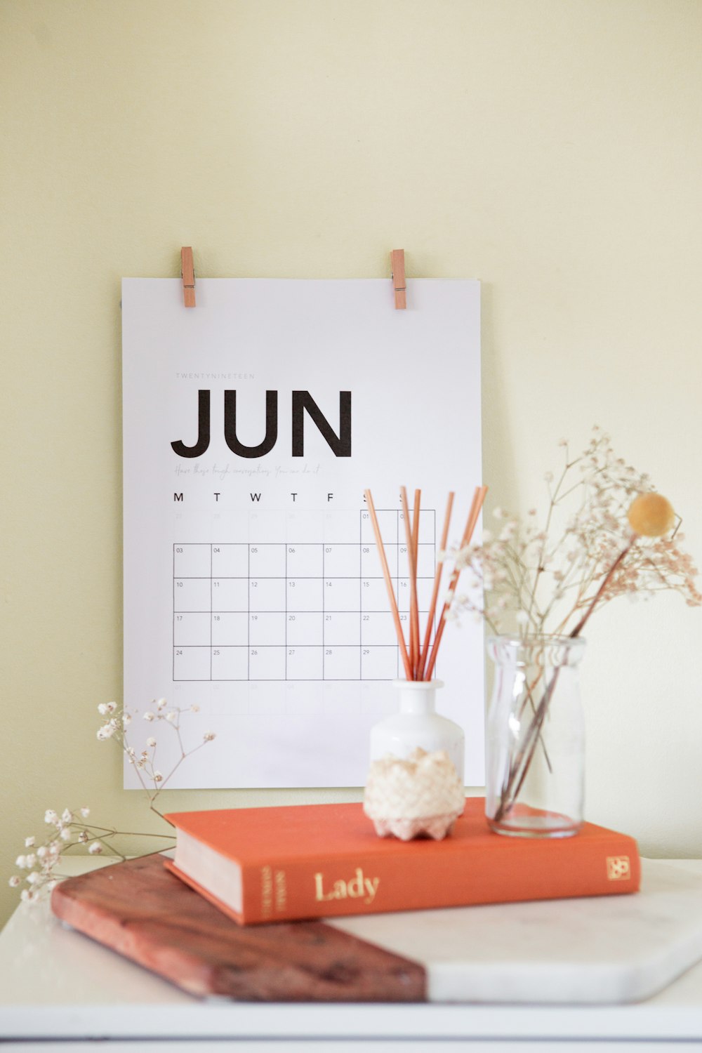 vase on book near calendar