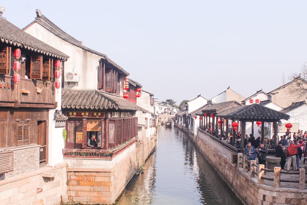 canal between concrete buildings during daytime